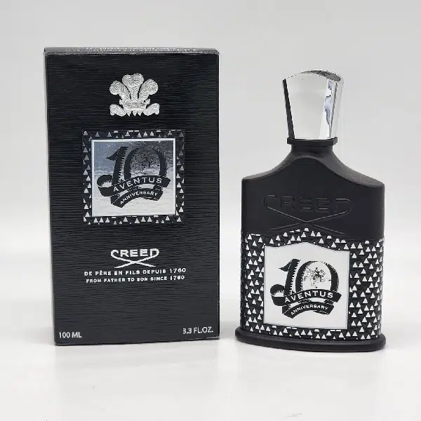 A stylish Creed 40th Anniversary cologne bottle with its black packaging.
