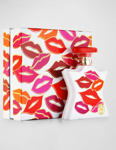 Perfume bottle and box decorated with colorful lip prints.