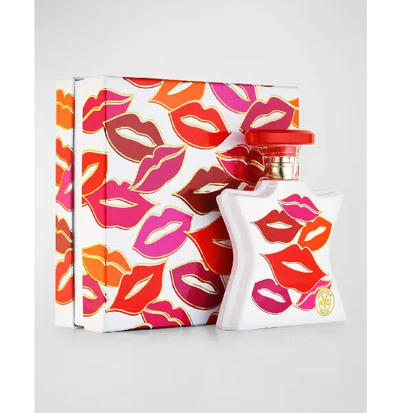 Perfume bottle and box decorated with colorful lip prints.