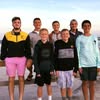 Group of young men posing outdoors during sunset.