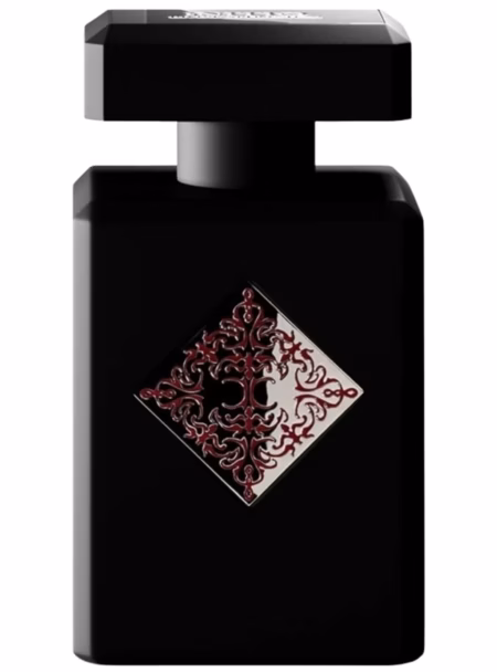 Black perfume bottle with ornate red filigree