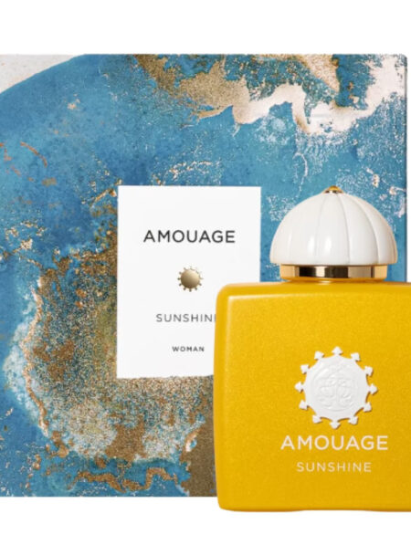Yellow perfume bottle with a sun design next to a blue and gold marbled box.